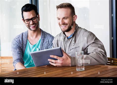 Smiling Gay Couple Using Tablet Stock Photo Alamy