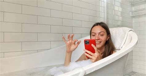Premium Photo Brunette Woman In Bathtub With Smartphone In Foam