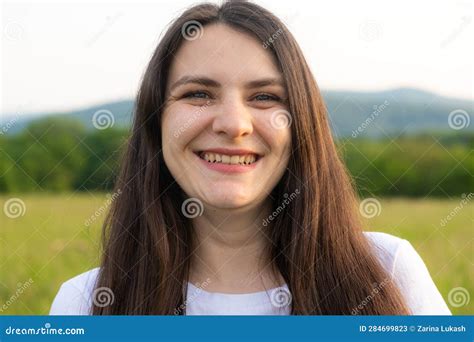 Portrait Of A Year Old Brunette Woman Looking At The Camera Smiling In Nature Stock Image