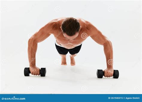 Man Athletic Body Bodybuilder Posing With Dumbbells With Naked Torso Abs Full Length In The