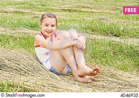 A Pretty Girl Sitting In A Field Free Stock Images Photos