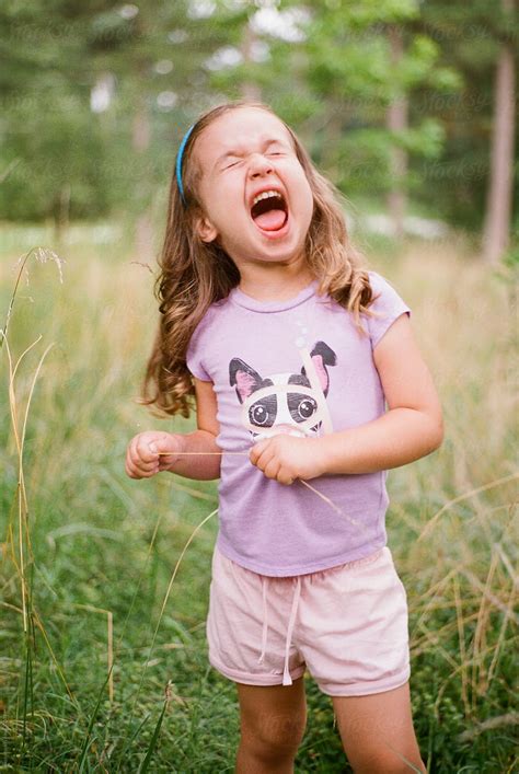 "Cute Young Girl Making A Funny Face In A Field" by Stocksy Contributor ...