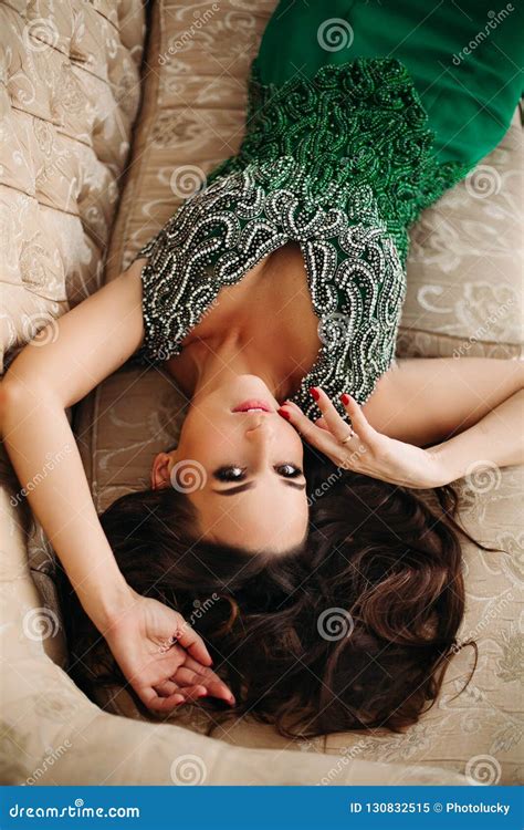 Above View Of Beautiful Brunette Woman With Perfect Volumed Hair Seductive Touching Face Stock