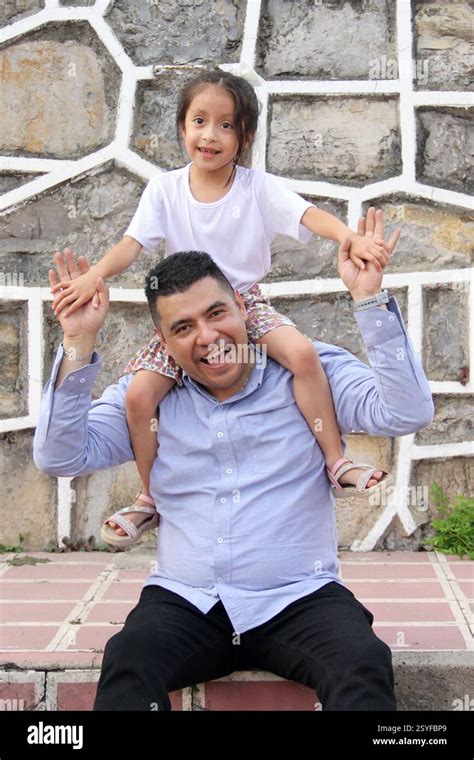 Divorced Single Dad Carries His Year Old Latina Daughter On His Shoulders In Piggyback Style