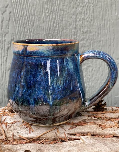 A Blue Mug Sitting On Top Of A Wooden Table