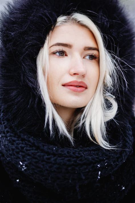 Portrait Of Beautiful Blonde Girl In A Warm Fur Coat Outdoor In A Snowy Forest Stock Photo