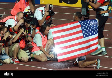 US American Sprinter Tyson Gay Poses For Photographers With An American Flag After His Victory