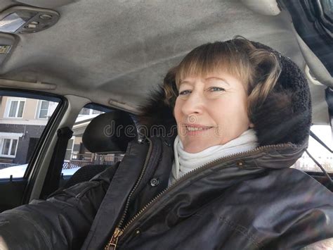 Middle Aged Woman In A Car Taking Selfie While Enjoying A Drive Female Mature Driver Posing