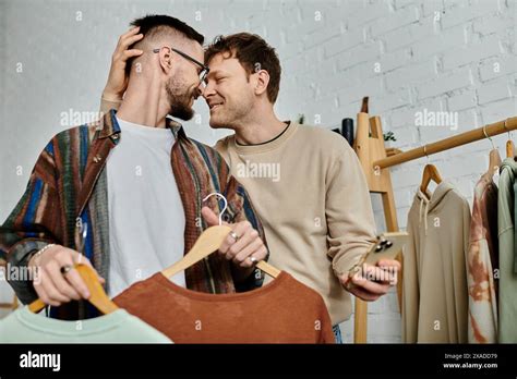 Two Men Members Of A Gay Couple Stand Side By Side In A Designer Workshop Stock Photo Alamy