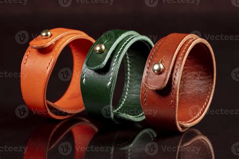 A Group Of Multi Colored Leather Belts On A Black Background 20129086