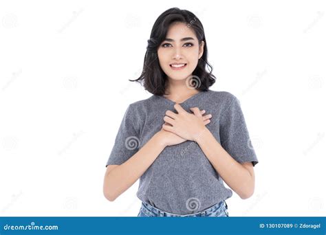 Pretty Asian Woman With Appealing Smile Keeps Hands On Chest E Stock