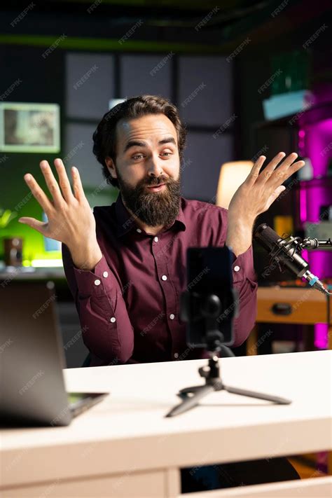 Free Photo | Influencer making energetic hand movements filming with