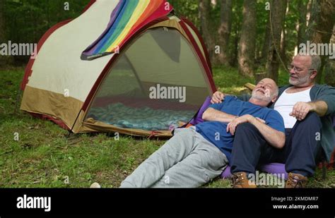 Slow Motion Of Two Gay Men Embracing With Pride Flag And Tent In Front Of Stock Video Footage