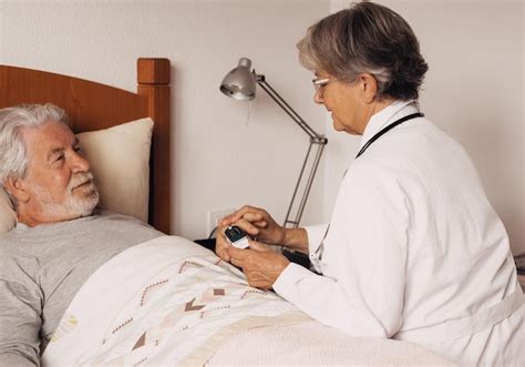 Premium Photo Female Doctor Measures Blood Oxygen To A Senior Bearded