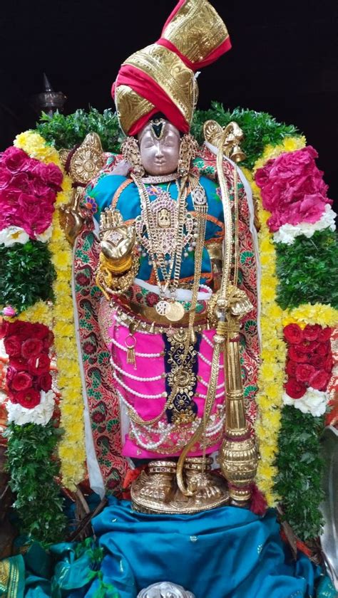 The Statue Is Decorated With Flowers And Decorations