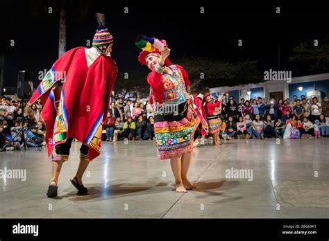 Dancers in colourful costumes performing traditional Huayno Cusqueño Peruvian dance to crowds in ...