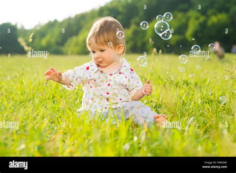 Babe Playing On The Lawn Stock Photo Alamy