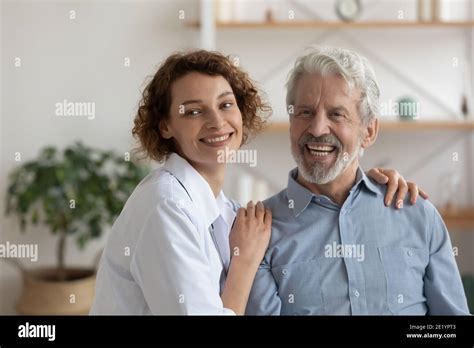 Dreamy Pleasant Nurse Caregiver Supporting Elderly Mature Patient Stock Photo Alamy