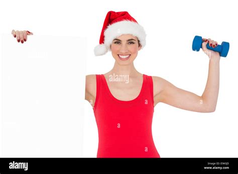 Festive Fit Brunette Holding Page And Dumbbell Stock Photo Alamy