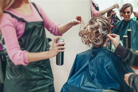 Stylist And Hairdresser Doing Hairstyle For Young Woman Stock Image