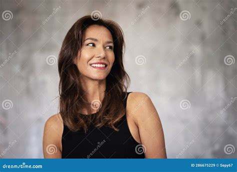 Portrait Of A Beautiful Brunette Haired Woman Cheerful Smiling Against Grey Bacgkround Stock