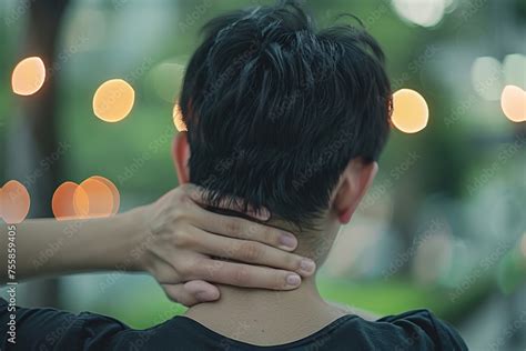Person Clinging To His Neck With Both Hands And His Face Contorted In