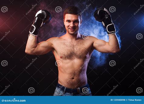 Studio Portrait Of A Muscular Boxer In Professional Gloves Of Eu Stock