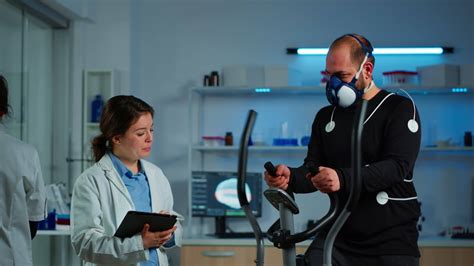 Medical researcher talking with sportsman while measuring his endurance