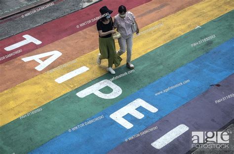 A Pedestrians Couple Passes By Gay Friendly Xinmen Shopping Promenade Decorated With Rainbow