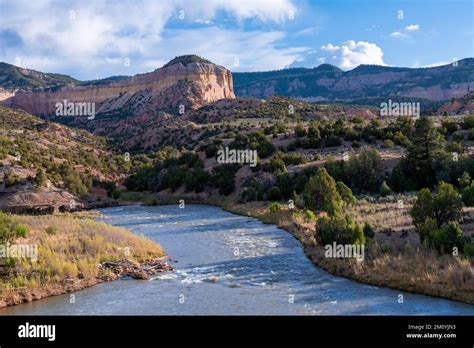 Rio Chama River Flows Through A Colorful Desert Landscape Of Mesas And