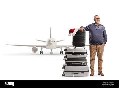 Mature Man Packed For A Christmas Holiday Leaning On Suitcases Isolated On White Background