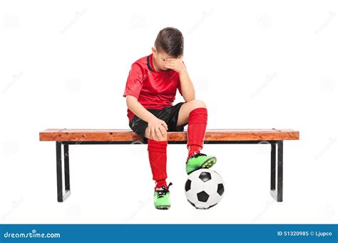 Sad Kid In Soccer Uniform Sitting On A Bench Stock Photo - Image: 51320985