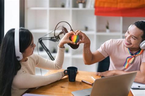 A Charming And Cheerful Asian Gay Radio Host Enjoys Chatting While Recording An Audio Podcast