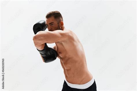 Man Athletic Bodybuilder Poses In Boxing Gloves With Nude Torso Abs In