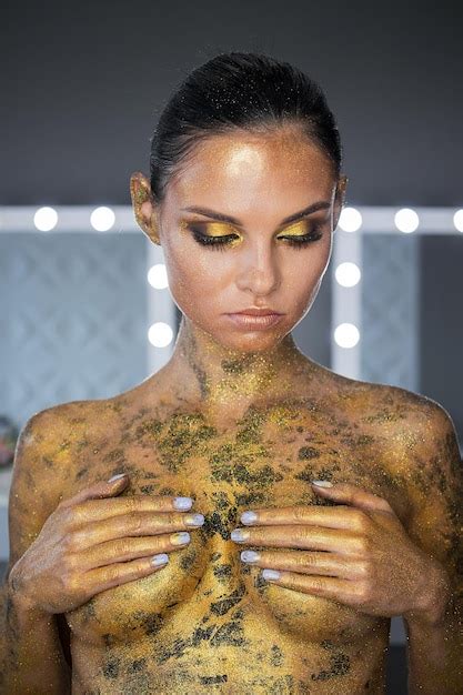 Premium Photo Hot Naked Woman In Glitters Covering Breasts And Posing With Snake On Head