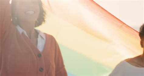 Lesbian Couple Women Or Pride Flag On Beach Date In Trust Bond Or Security For Gay Equality