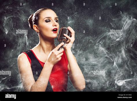 Beautiful Blonde Woman Singer With A Microphone Stock Photo Alamy