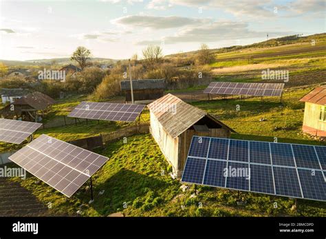 Aerial Top Down View Of Solar Panels In Green Rural Village Yard Stock