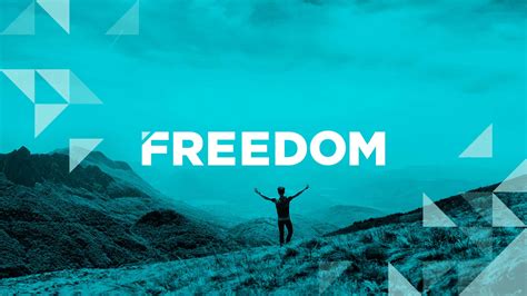 Download Freedom A Man Standing On Top Of A Mountain