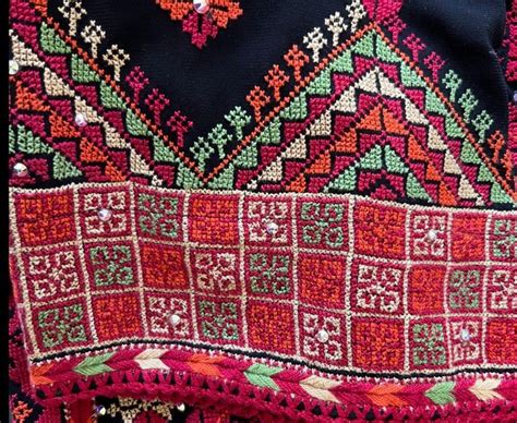 A Close Up Of A Colorful Cloth With Beads On The Bottom And An