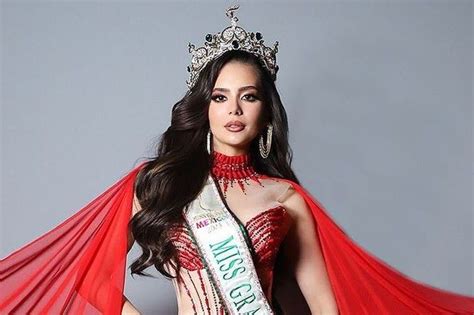 a woman in a red dress and tiara posing for the camera with her hands ...