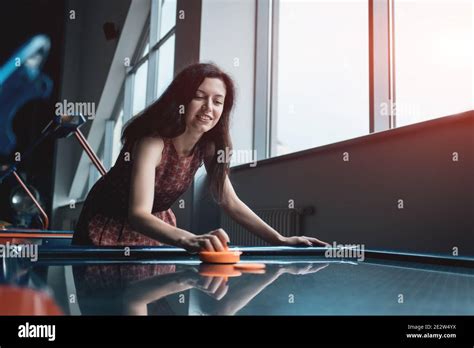 Beautiful Brunette Female Playing Air Hockey With Friend Stock Photo Alamy