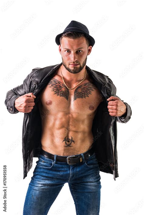 Muscular Man With Leather Jacket On Naked Torso Wearing Fedora Hat Isolated On White