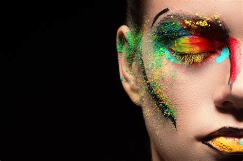 Premium Photo Close Up Of Woman With Face Paint Against Black Background