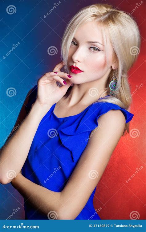 Elegant Beautiful Women Blonde With Red Lips In A Blue Dress In The