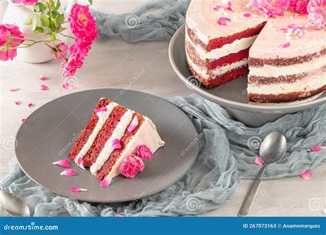 Red Velvet Naked Cake With Fresh Roses And Swiss Buttercream On Kitchen Countertop Stock Image