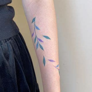 A Woman With A Tattoo On Her Arm