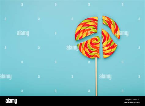 Lollipop Broken Into Pieces On Blue Background Top View With Copy