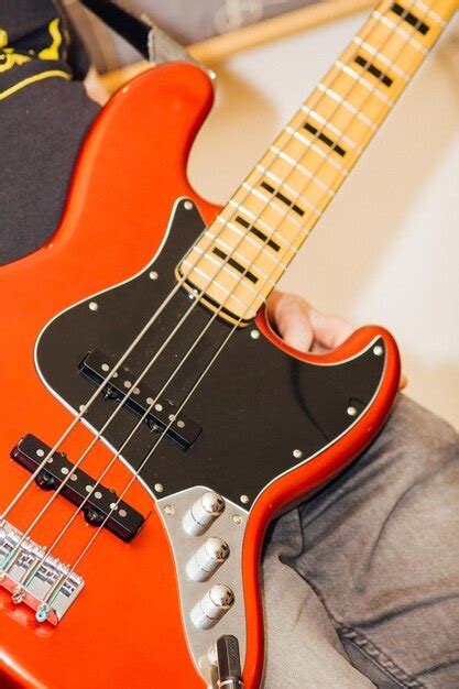 Premium Photo Midsection Of Man Holding Guitar In Studio