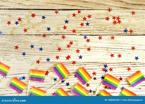 Bright Rainbow Gay Flag On Wooden Background Paper Confetti Top View With Space For Text Copy